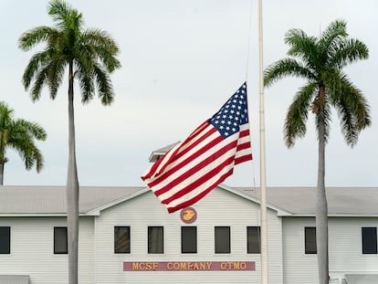 In this photo reviewed by U.S. military officials, a flag flies at half-staff in honor of the U.S. service members and other victims killed in the terrorist attack in Kabul, Afghanistan, at Marine Corps Security Force Company, Aug. 27, 2021, in Guantanamo Bay Naval Base, Cuba.
