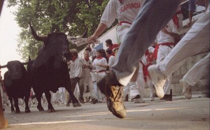 Los mozos corren delante de los toros, durante el encierro de los Sanfermines en Pamplona, en 1995.