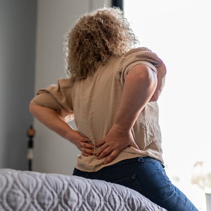Mature woman with backache at home