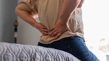 Mature woman with backache at home