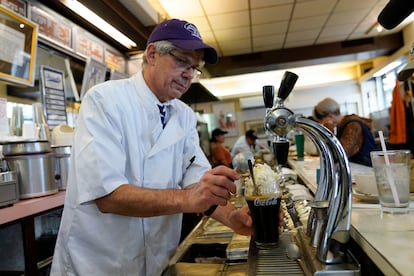 John Philis, a third-generation owner of the Lexington Candy Shop, prepares a Coke float at the luncheonette, Thursday, Sept. 28, 2023, in New York.