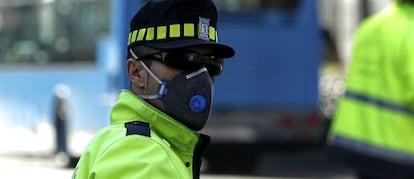 Un agente regulaba el tráfico ayer protegido con una mascarilla en el paseo de las Acacias de Madrid.