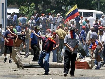 Manifestantes chavistas arrojan piedras a la policía en Caracas.