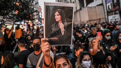 (FILES) A protester holds a portrait of Mahsa Amini  during a demonstration in support of Amini, a young Iranian woman who died after being arrested in Tehran by the Islamic Republic's morality police, on Istiklal avenue in Istanbul on September 20, 2022. On October 19, 2023, The European Parliament, awarded the EU's top rights award, the Sakharov Prize, to Mahsa Amini, who died in Iranian custody, and the "Woman, Life, Freedom" movement her death triggered. (Photo by Ozan KOSE / AFP)