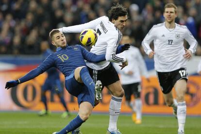Benzema disputa el cuero con Hummels, de Alemania.
