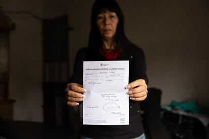 Mirta Hashimoto shows a prescription for the medication her daughter Cielo needs to continue her treatment. 