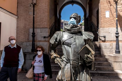 A statue of Miguel de Cervantes, complete with face mask, In Toledo this week.