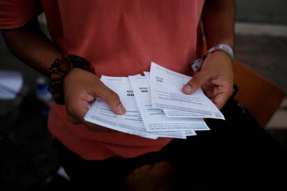 A student holds ballots to distribute them to citizens as he protests in favour of the banned October 1 independence referendum in Barcelona