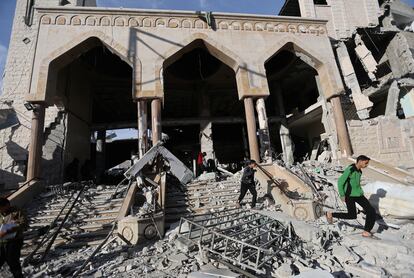 Palestinians inspect the site of an Israeli strike on a mosque in Rafah in the southern Gaza Strip, February 12, 2024. 