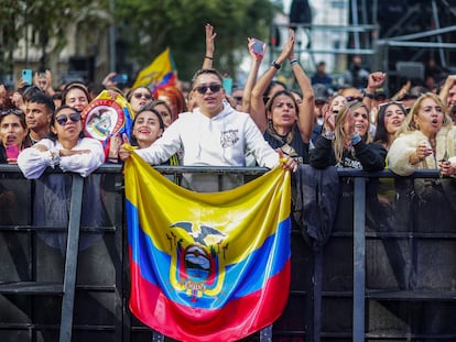 A man holds an Ecuadorian flag during a concert by Colombian Carlos Vives at the Puerta de Alcalá in Madrid, on the occasion of the celebration of Hispanic Heritage, on October 14, 2023.