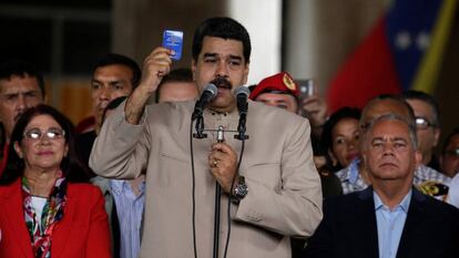 Nicolas Maduro holds up a copy of the Venezuelan Constitution.