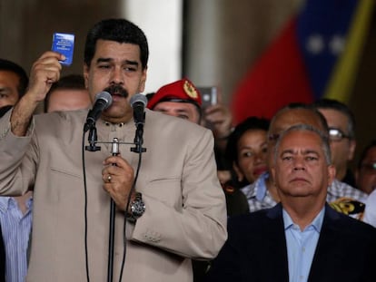 Nicolas Maduro holds up a copy of the Venezuelan Constitution.