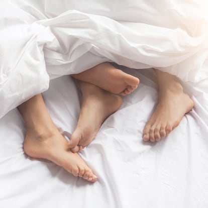 Young couple man and woman intimate relationship on bed feet