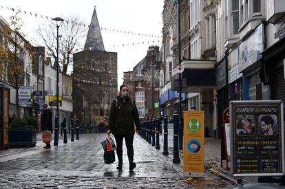 A woman walking down an empty street in Dover.