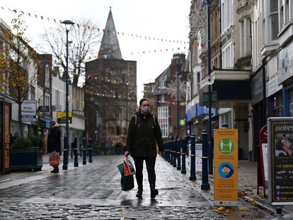 A woman walking down an empty street in Dover.
