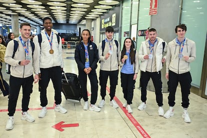 Los atletas españoles Ana Peleteiro (3i), Paula Sevilla (3d), Lester Lescay (2i), Óscar Husillos (2d), Markel Fernández (c y finalmente baja), Manuel Guijarro (i) y Bernat Erta (d) posan a su llegada al aeropuerto Adolfo-Suárez de Madrid el pasado 10 de marzo.