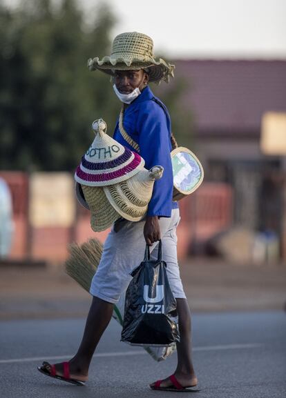 Sudáfrica. Un hombre con mascarilla vende sombreros tradicionales en la calle en Daveyton, al este de Johannesburgo, el martes 24 de marzo de 2020, un día después de que el país entrase en un cierre nacional durante 21 días para luchar contra la propagación del nuevo coronavirus. Para la mayoría de las personas, el virus solo causa síntomas leves o moderados. Para otros, puede causar enfermedades más graves, especialmente en adultos mayores y personas con problemas de salud existentes. Sudáfrica era entonces ya el país del continente con más afectados, por encima de 700. Los vendedores ambulantes han perdido su forma de ganarse la vida.