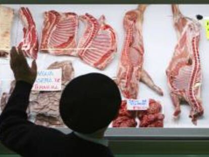 Un hombre observa el escaparate de una carnicería en el mercado de Vitoria. EFE/Archivo