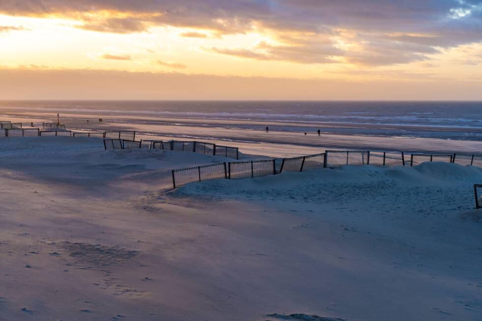 Paso de la playa de dunas de De Haan.