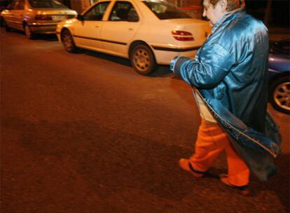 Una mujer camina en bata tras ser desalojada de su vivienda.