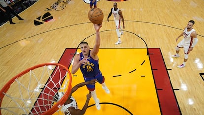 Denver Nuggets center Nikola Jokic (15) shoots against Miami Heat forward Jimmy Butler during the first half of Game 3 of basketball's NBA Finals on Wednesday, June 7, 2023, in Miami. (Kyle Terada/Pool Photo via AP)