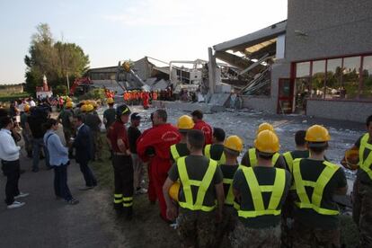 Trabajadores de los equipos de rescate ante una fábrica en Medolla.