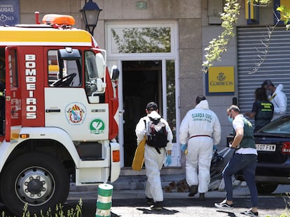 Agentes de criminalística de la Guardia Civil entran en el edificio de Sigüeiro donde se produjo el incendio.