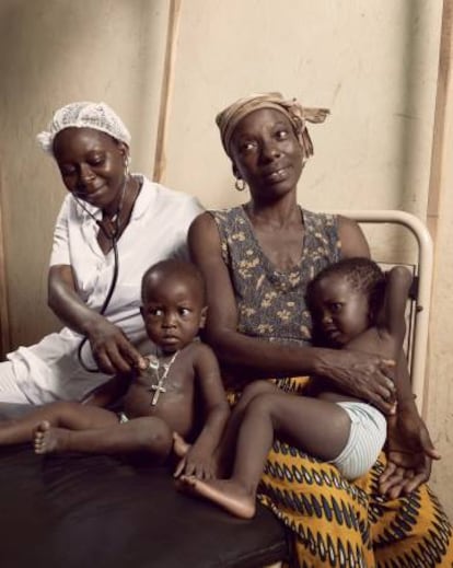 Arielle Agrokannoun (izquierda), examina a un ni&ntilde;o cuya madre acaba de dar a luz por segunda vez en un centro de salud de Ben&iacute;n. 