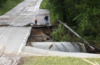 Dos hombres comprueban los destrozos en una carretera carretera dañada por las inundaciones, en la ciudad alemana Simbach am Inn, el 2 de junio.