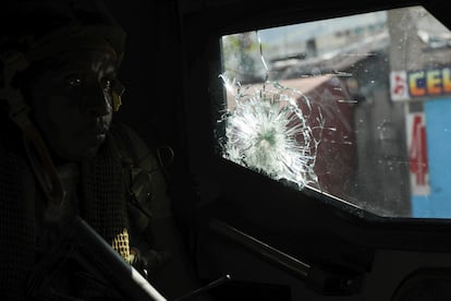 A Kenyan police officer, part of a U.N.-backed multinational force, patrols a street in Port-au-Prince, Haiti.