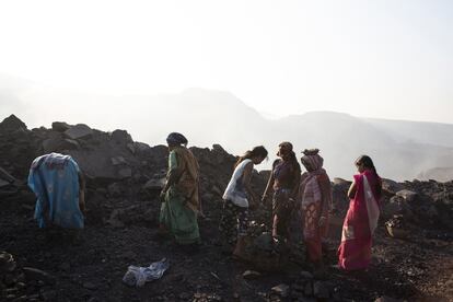 Devi, de 26 años, (en rosa) limpia el carbón con su hermana y otras mujeres de su pueblo en la mina de Decco. Ella ha estado recolectando carbón desde que era una adolescente para complementar los ingresos de su esposo que trabaja como cargador de carbón en una bahía de carga cercana. "Esta es la única opción para trabajar aquí, es difícil y agotador, pero me da un poco de dinero", declara.