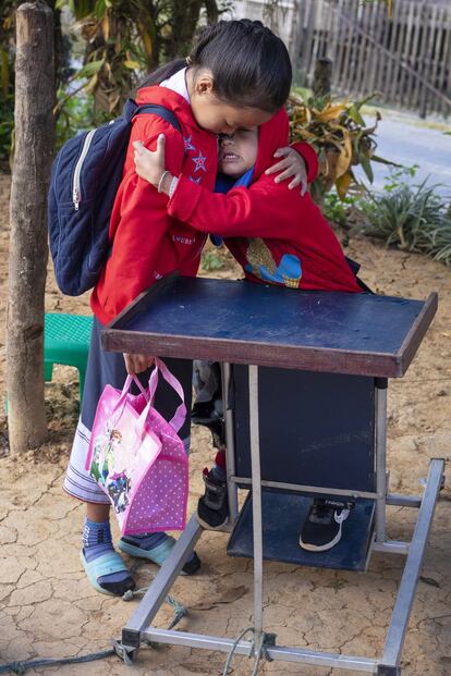 Oi abraza a su hermano Kum: la pequeña Oi, de 10 años, es como una extensión de Kum: le ayuda, le cuida y juega con él.