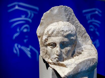 The marble head of a young man, a tiny fragment from the 2,500-year-old sculptured decoration of the Parthenon Temple on the ancient Acropolis, is displayed during a presentation to the press at the new Acropolis Museum in Athens, Nov. 5, 2008.