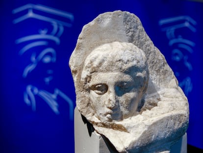 The marble head of a young man, a tiny fragment from the 2,500-year-old sculptured decoration of the Parthenon Temple on the ancient Acropolis, is displayed during a presentation to the press at the new Acropolis Museum in Athens, Nov. 5, 2008.