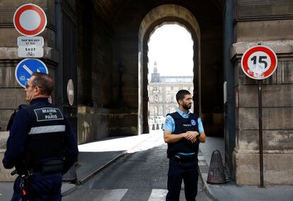 French police officers keep watch outside of the Louvre museum, closed for security reasons, in Paris.