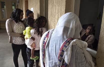 Una mujer con su hija (segundo plano) espera a ser atendida en compañía de dos extensionistas del programa de extensión sanitaria que la han acompañado hasta el centro de salud de Afincho Ber desde su barrio en Adís Abeba, la capital de Etiopía.