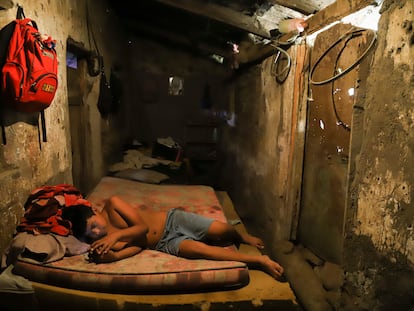 Cesar Velasquez, 14, lies on a mattress, while spending time with his cell phone, at his grandmother's house where he now lives, because his parents were detained during the government's crackdown on its war against drugs, in Santa Ana, El Salvador, Wednesday, Jan. 31, 2024.