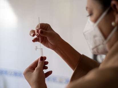 A woman prepares to take an antigen test.