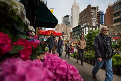 Pedestrians walk past plants displayed for sale in Manhattan's flower district in New York, U.S., on Thursday, March 24, 2016. With an El Nino in the equatorial Pacific, winter across the contiguous U.S. was the warmest in history, and new daily high temperatures were posted last week in Philadelphia, Trenton, Boston and New York's Central Park