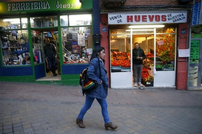 A woman walks past storefronts. In the Entrevías and San Diego neighborhoods, there are more than 4,000 recipients of the Minimum Insertion Income, a public subsidy for Spain’s poorest citizens.