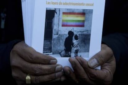 A protester from Hazte Oir holds brochures titled 'The laws of 'Sexual indoctrination' during a Madrid protest on Wednesday.