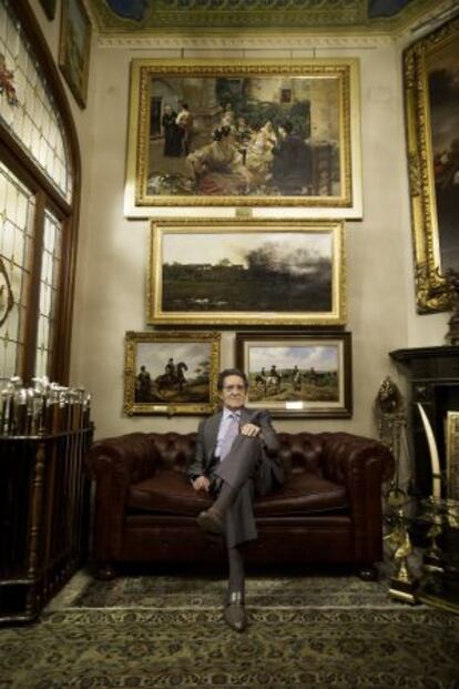 Mariano Bellver inside his home, with a few items from his collection on display.