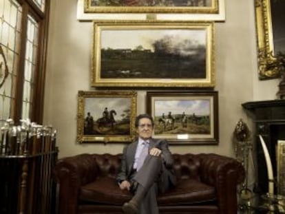 Mariano Bellver inside his home, with a few items from his collection on display.