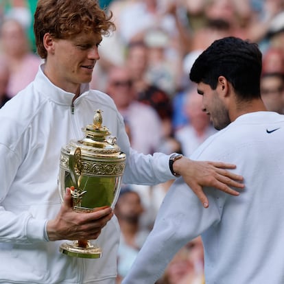 Tennis - Wimbledon - All England Lawn Tennis and Croquet Club, London, Britain - July 13, 2025 Italy's Jannik Sinner celebrates with the trophy after winning the men's final alongside runner up Spain's Carlos Alcaraz REUTERS/Stephanie Lecocq