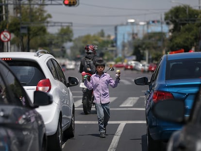 Un niño realiza malabares entre las filas de vehículos el 10 de junio de 2020, en Ciudad de México (México). En América Latina, la covid-19 ha incrementado el trabajo infantil.