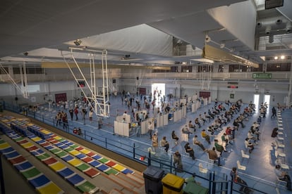 Health workers administering the AstraZeneca vaccine at a sports facility on the campus of Seville University.