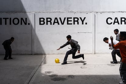 A group of students plays in the courtyard of the international school.