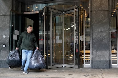 An immigrant from Colombia leaves the Row Hotel with his belongings, Tuesday, Jan. 9, 2024, in New York