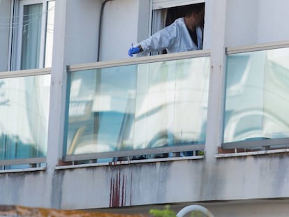 An officer inspects the home where the body of Manuela C. S. was found.