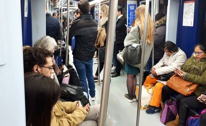 Viajeros en un tren parado en la estación de Tribunal.